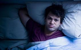Mental Illness Man in Bed - Depression and suicidal thoughts are up in America.
