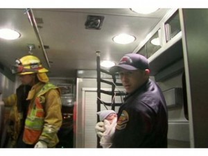 A paramedic cares for a baby born along the 605 freeway in Los Alimitos, California. A paramedic cares for a baby born along the 605 freeway in Los Alimitos, California.