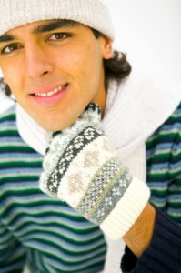 Young man wearing hat, scarf, and gloves