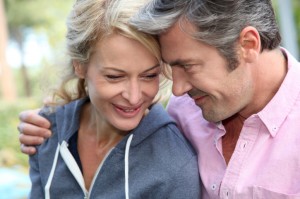 Mature couple talking, smiling.
