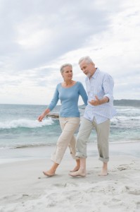 Mature couple walking on beach