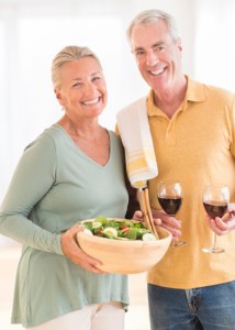 mature couple carrying food and wine