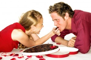 couple lying on floor with box of chocolates