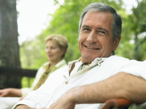 mature man relaxing on park bench.