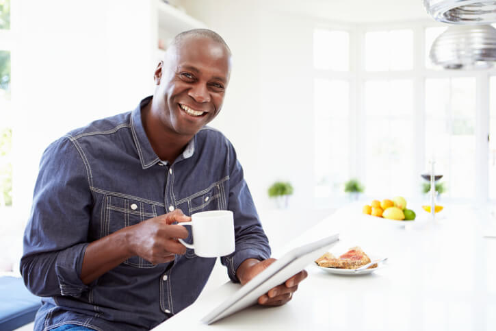 mid adult man sitting, drinking coffee