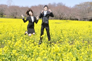 Man and woman frolicking in a blooming field.