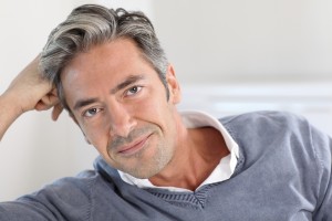 mid adult man sitting on sofa, portrait