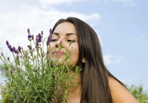 woman smelling flowers.