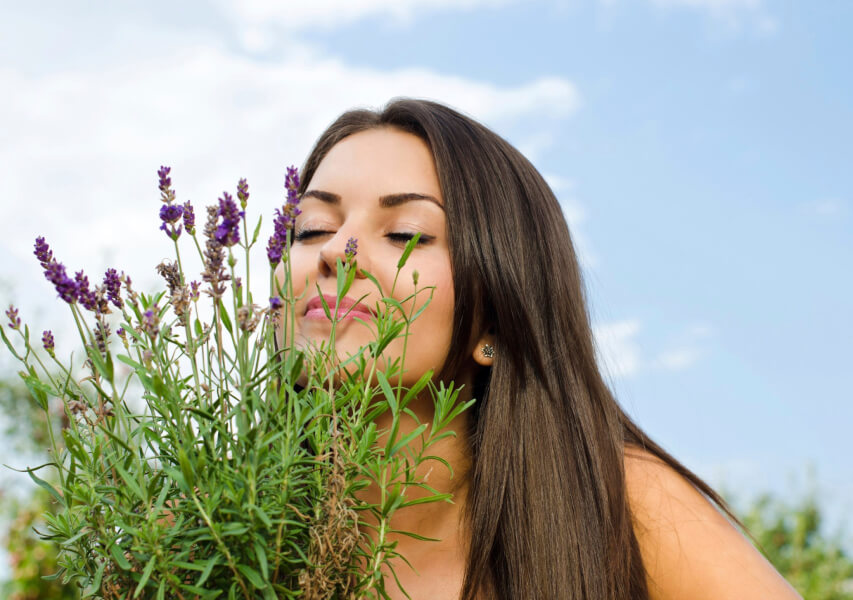 woman smelling flowers.