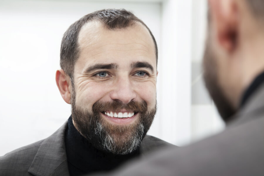 man smiling in mirror