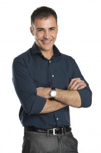 Man smiling, arms crossed.