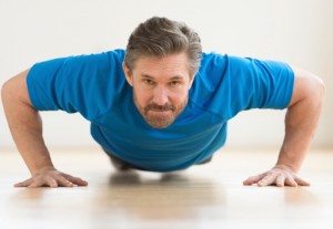 mid adult man doing push ups
