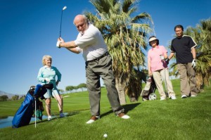 Mature man playing golf