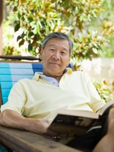 man relaxing outdoors with a book