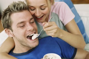 woman feeding man ice cream