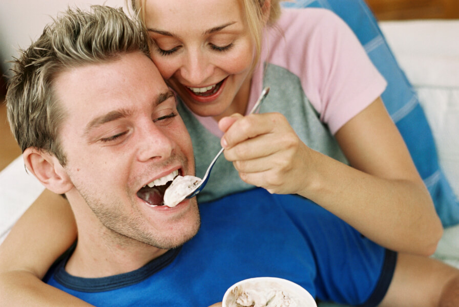 woman feeding man ice cream
