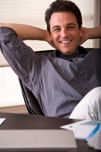 Man relaxing at an office desk