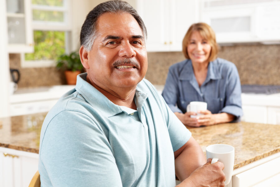 mature man having coffee with wife in kitchend