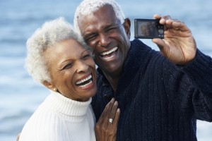 senior couple smiling, taking a selfie