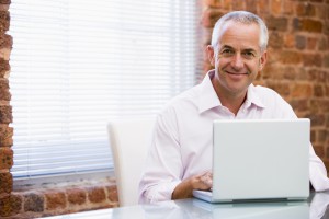 mid adult man using a laptop computer