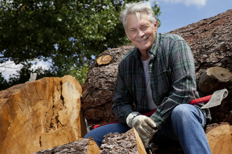 mature man, resting after chopping wood.