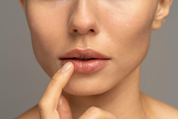 Woman with a finger next to her lip
