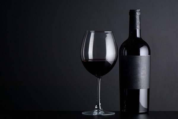 Bottle of wine next to a glass