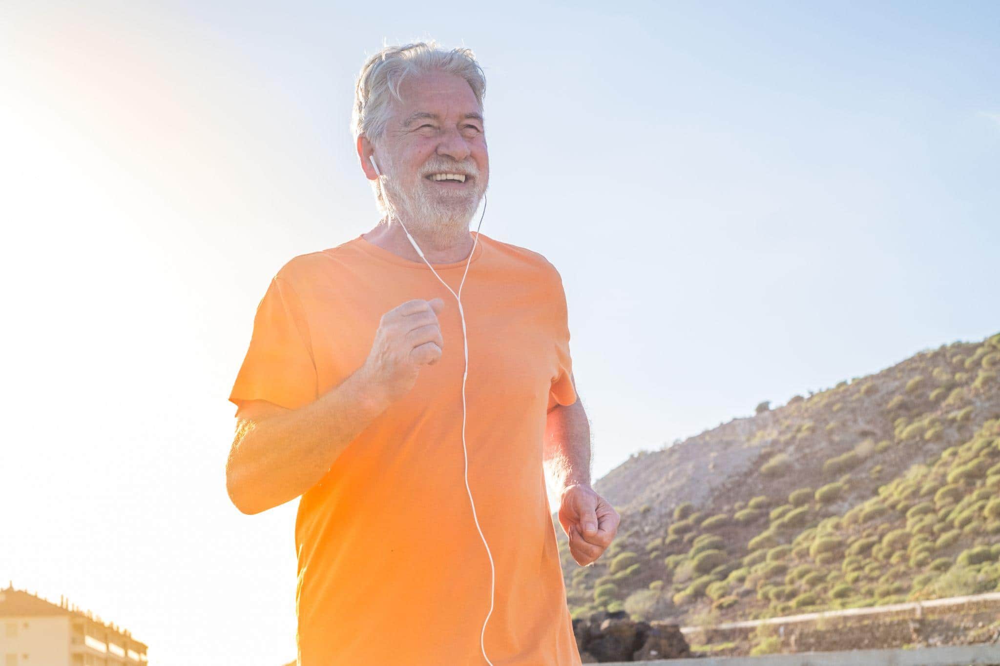 A Man Jogging with Earphones in His Ears A Man Jogging with Earphones in His Ears