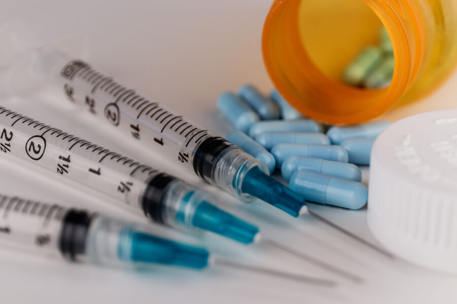 Syringes and blue pills.