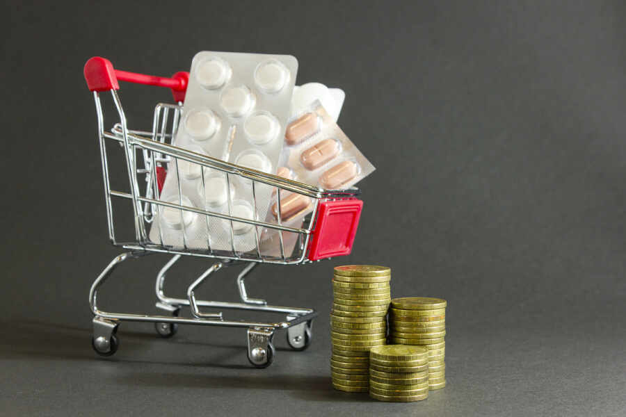 Miniature shopping cart with pills.