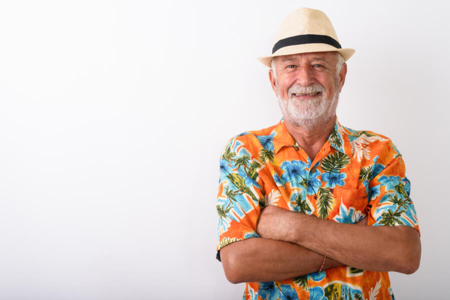 Man standing with his arms crossed and smiling.