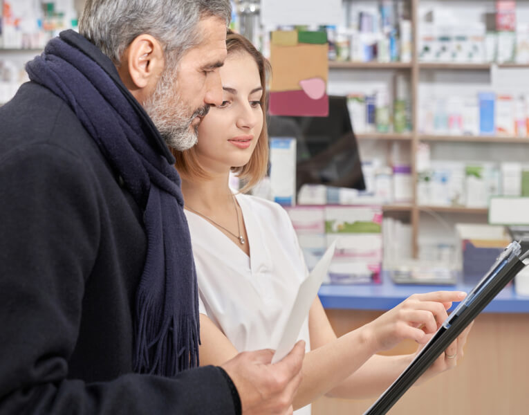Man consulting a pharmacist.