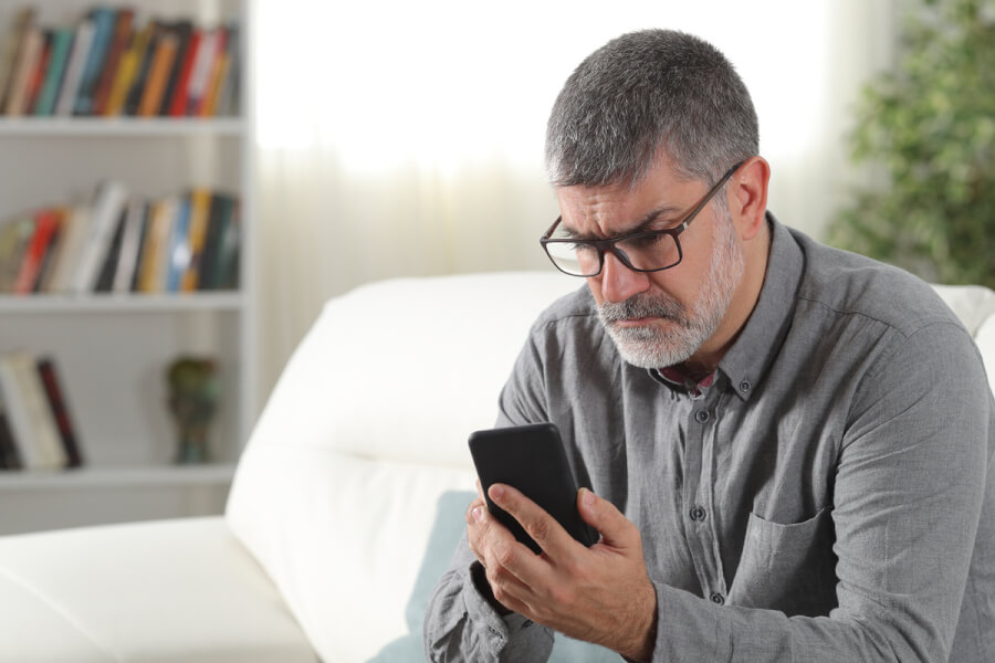 Man looking intently at his phone.