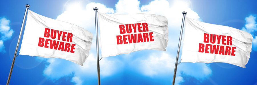 Three white flags with the words buyer beware on them.