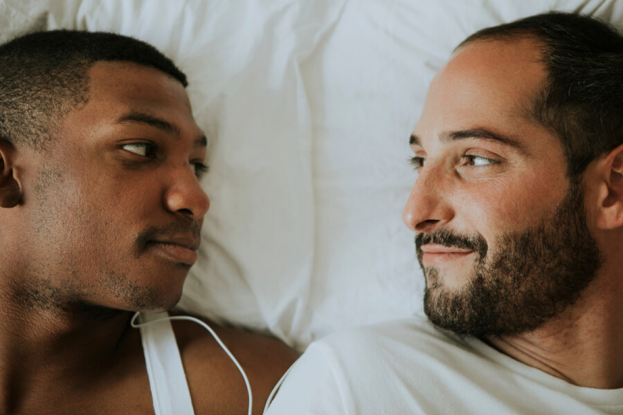 Two men smiling at each other.