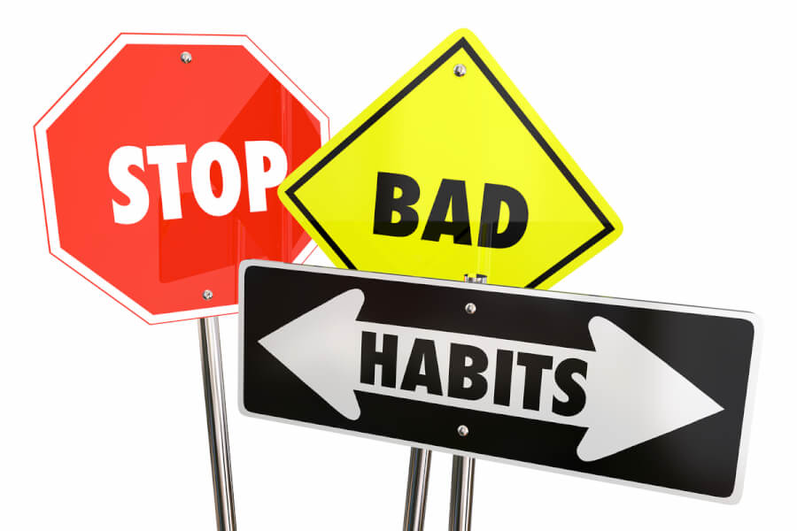 Three street signs spelling out stop bad habits.