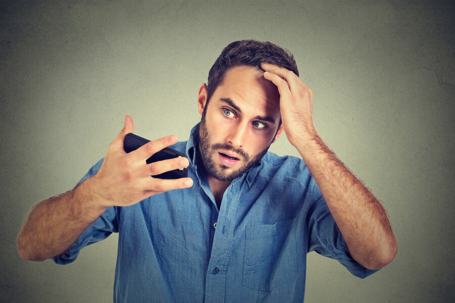 Man looking at his hair line.