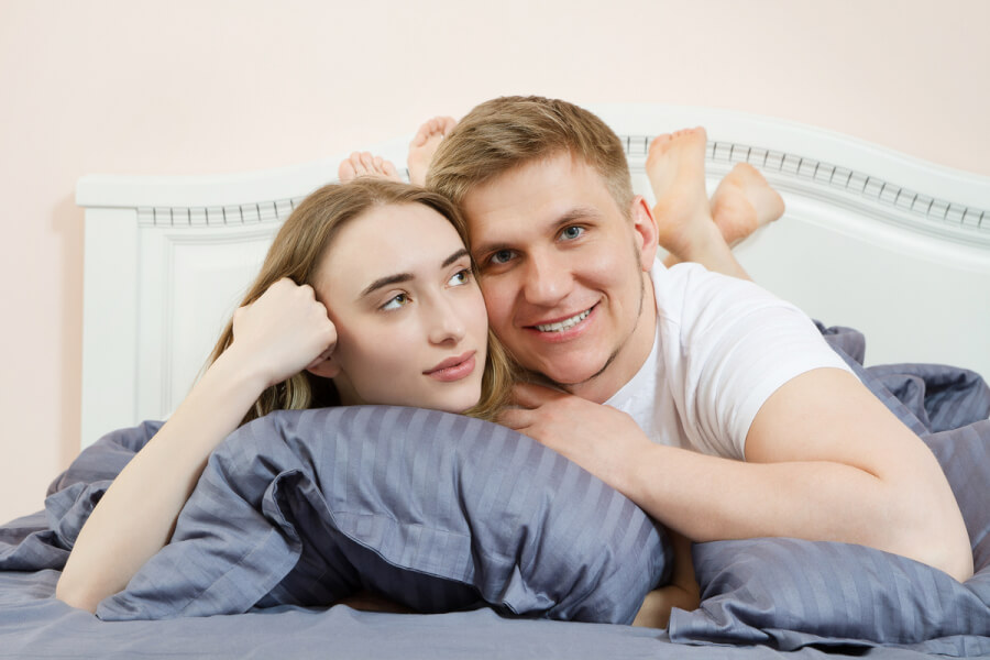 Happy couple lying together.