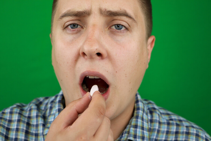 Man taking a pill.
