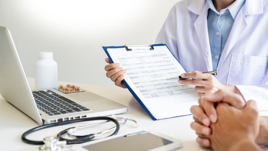 Medical doctor holding a clip board.