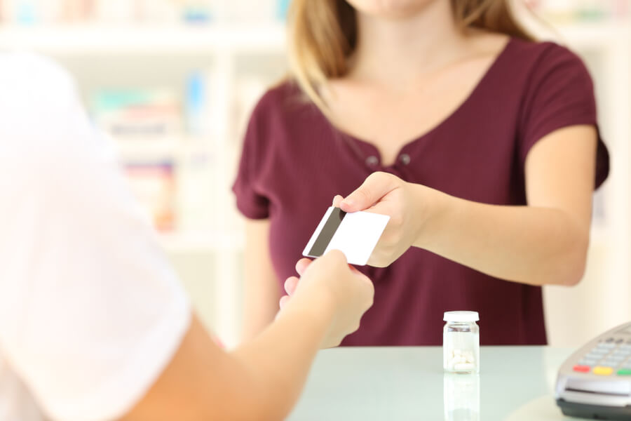 Woman making a purchase from a pharmacist.