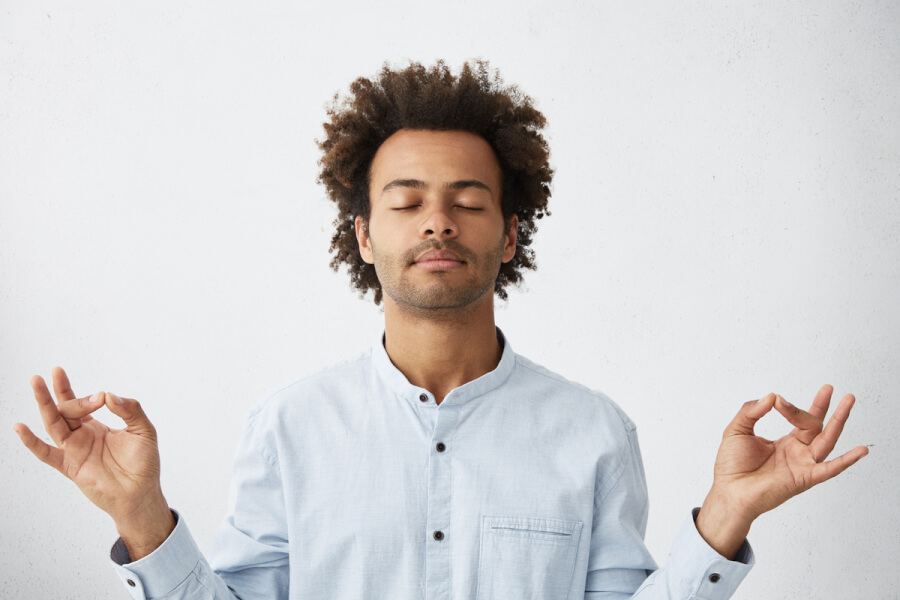 Man relaxing in a meditative position.