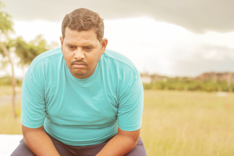 Man sitting looking sad.