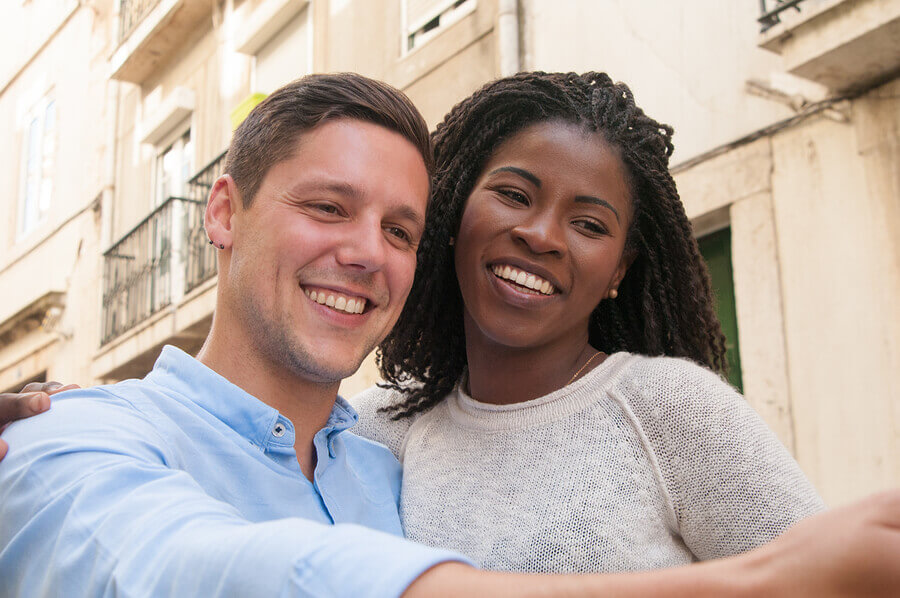 Smiling couple taking a selfie.