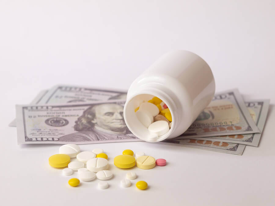 Pill bottle on its side with pills selling out.
