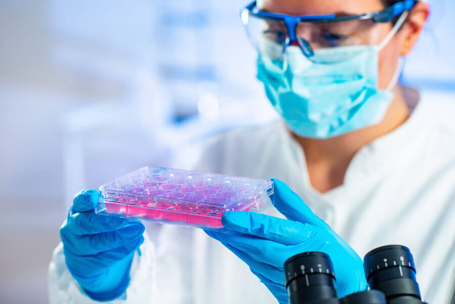 Lab technician looking at liquids.