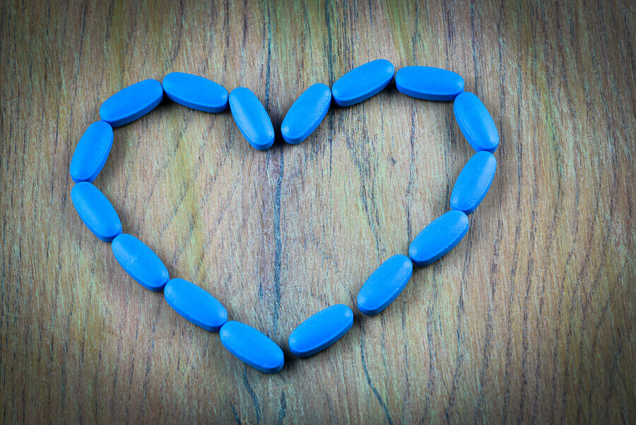 Blue pills formed into a heart.