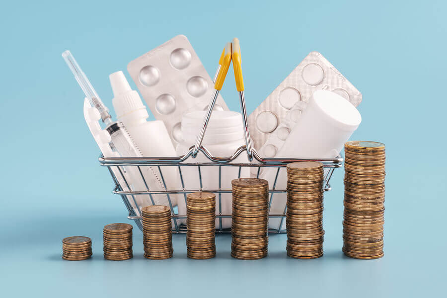 Small metal basket filled with pill packs and pill bottles.