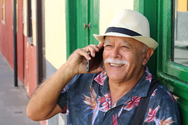Happy elderly man talking on a cell phone Happy elderly man talking on a cell phone
