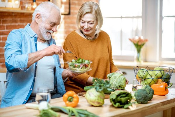 Older couple eating salad Older couple eating salad
